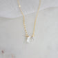 A clear, natural crystal quartz faceted teardrop set onto a 14k gold filled chain.