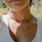 Tiny stones arranged in the order of the seven chakras or rainbow colors. Colors include: purple, blue, aqua, green, yellow, orange, and red. Modeled image.