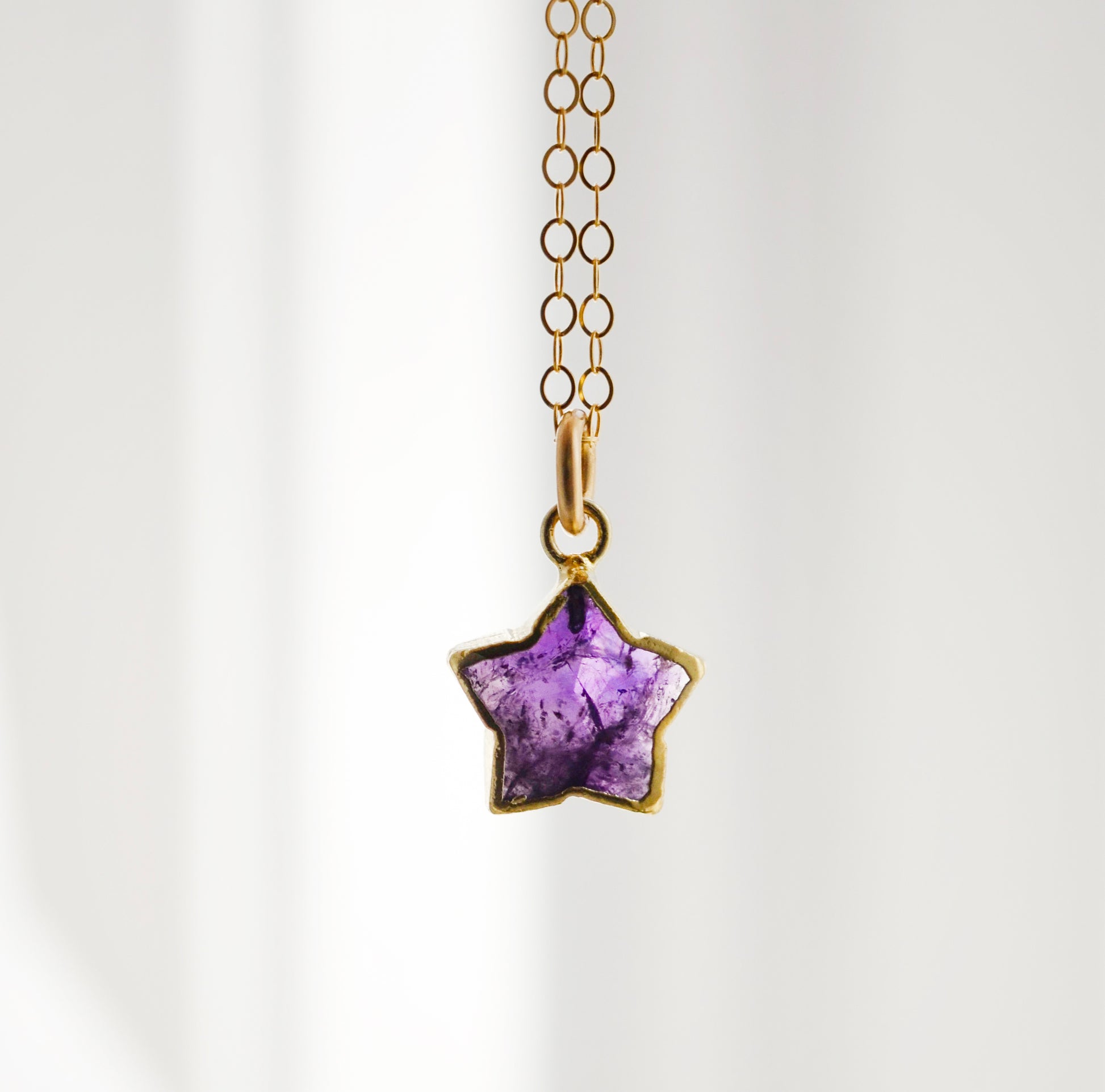 Dainty purple amethyst star necklace in gold filled.