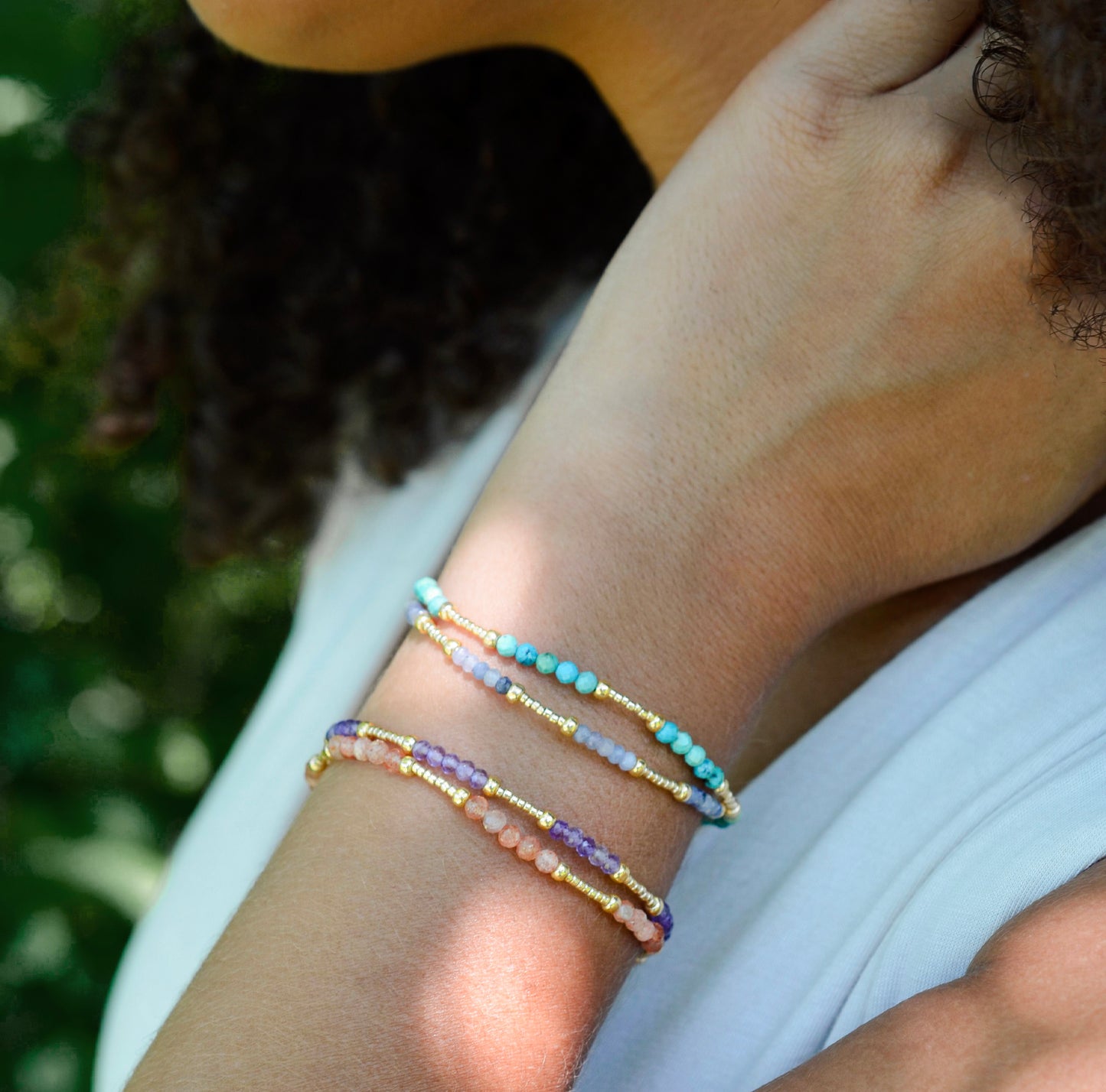 Handmade beaded gemstone crystal bracelet in gold filled or sterling silver. These bracelets feature a gemstone of your choice on a bracelet that can be stacked with others or worn alone. Modeled image.