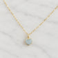 A delicate 14k gold-filled chain necklace with a small heart-shaped pendant featuring a light blue, natural aquamarine stone. Handmade in Connecticut by Gemnia.