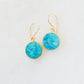 Real turquoise gemstones set in gold vermeil bezels and suspended from 14k gold filled ear wires. These handmade earrings feature smooth polished round stones. Artisan jewelry from Connecticut by GEMNIA.