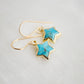 Side view. Minimalist celestial star earrings with turquoise stones set in gold. These dangles are handmade by Gemnia Jewelry in New england.