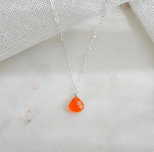 A dainty, real orange Carnelian gemstone teardrop pendant suspended from a sterling silver cable chain. This necklace is handmade and also comes in 14k gold filled.