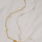 Gold and silver styles of the pearl chain necklace shown side by side. 