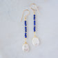 Natural blue lapis lazuli gemstone and white freshwater pearl long dangle earrings. The dangles are long and thin with oval freshwater pearls at the end. They come in 14k gold filled and sterling silver.
