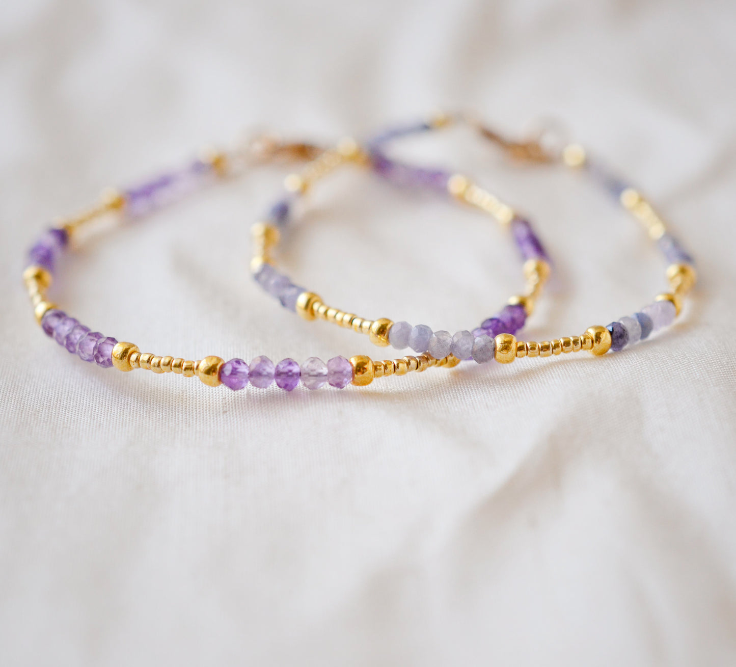 Handmade beaded gemstone crystal bracelet in gold filled or sterling silver. These bracelets feature a gemstone of your choice on a bracelet that can be stacked with others or worn alone. Modeled image showing: tanzanite, amethyst