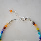 Close up image of the adjustable style in sterling silver. 
Tiny gemstone beaded bracelet in rainbow colors. Colors include: blue, green, yellow, red, orange, and purple.