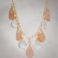 Orange, peach Sunstone and clear Crystal Quartz teardrops dangle off a 14k gold filled chain. 