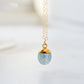 Stone pendant with a dainty aquamarine gemstone set on a 14k gold filled chain. The necklace is handmade in Connecticut by Gemnia Jewelry.