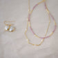 Genuine white freshwater pearls set onto a 14k gold filled chain. Shown with matching pearl earrings and a pick tourmaline necklace.
