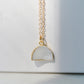 This necklace is handmade with a natural white druzy quartz pendant in a half-circle or crescent shape. Available in 14k gold filled.