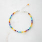 Tiny gemstone beaded bracelet in rainbow colors. Colors include: blue, green, yellow, red, orange, and purple.