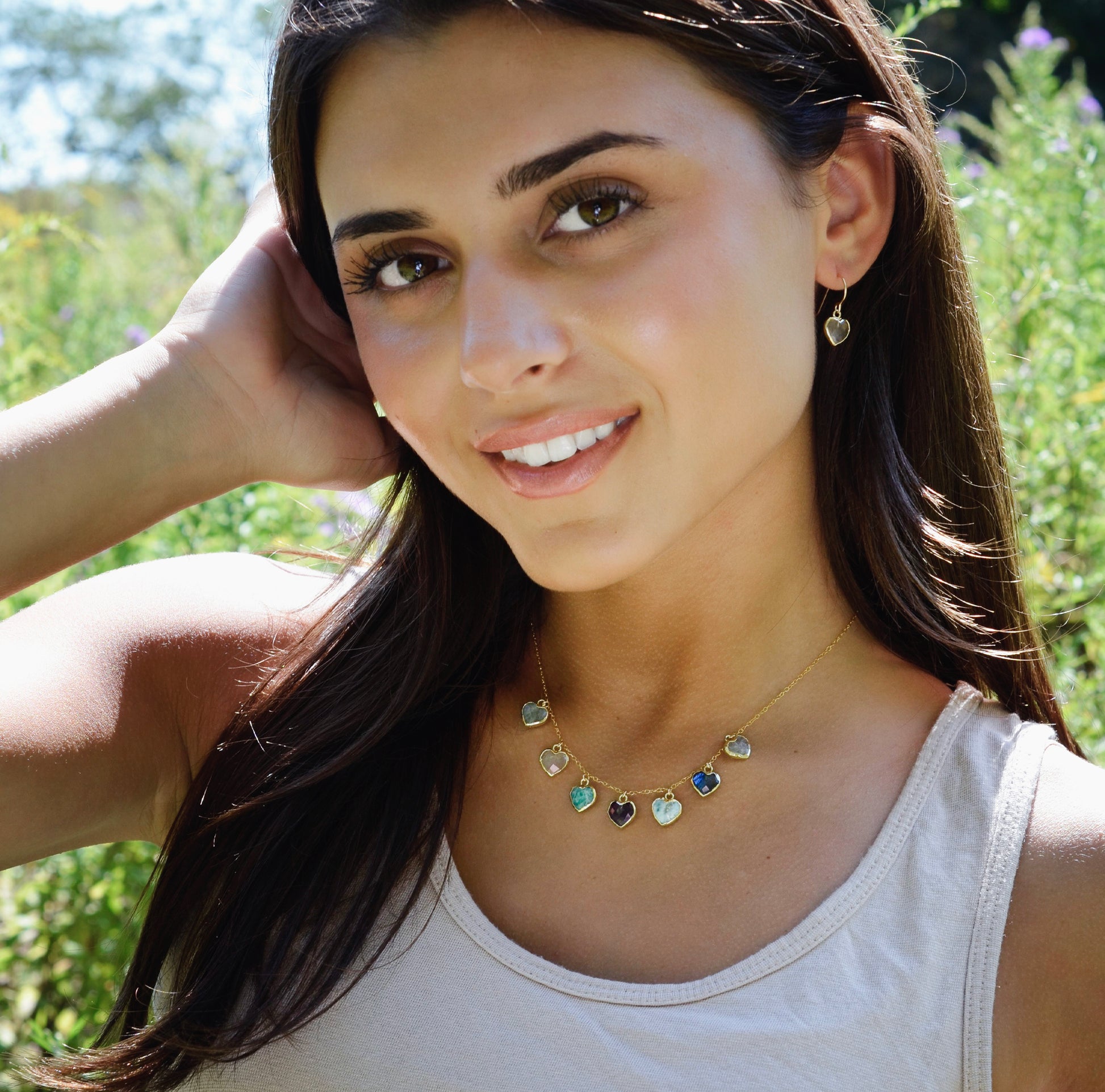 Modeled image: Handmade dainty heart necklace with heart-shaped gemstones on a 14k gold filed chain. Stones include: Aquamarine, Rose Quartz, Amazonite, Larimar, Labradorite, Amethyst, and Rainbow Moonstone