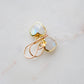 Natural rainbow moonstone stone heart earrings in gold. The stones are white, but flash blue with movement.
