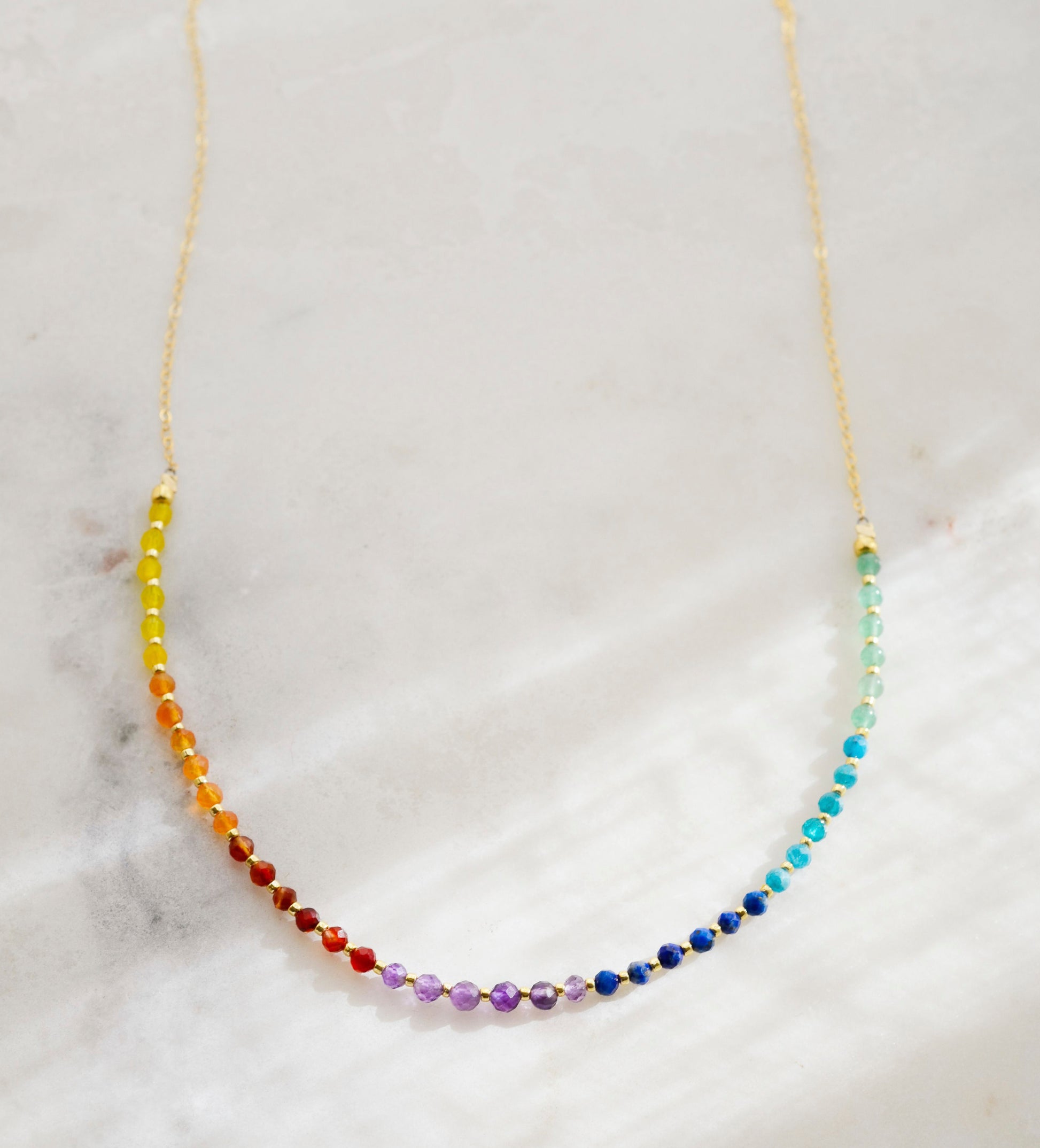 The single rainbow style is shown in 14k gold filled.