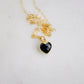 Black onyx heart pendant set on a 14k gold filled chain necklace.
