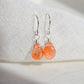 Handmade natural sunstone teardrop dangle earrings in sterling silver. These dainty, genuine stone earrings are made by Gemnia in Connecticut. 