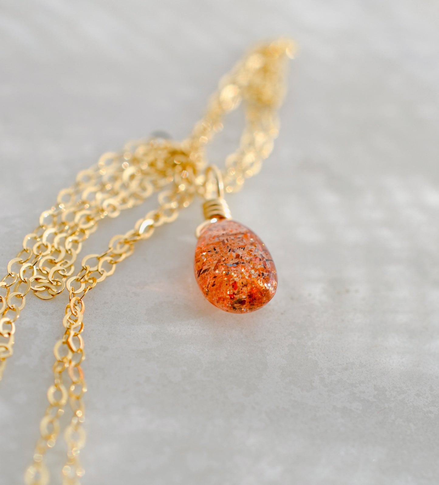 Orange Sunstone smooth polished teardrop pendant on a 14k gold filled chain. Stones shimmer in the light and when turned from side to side. 