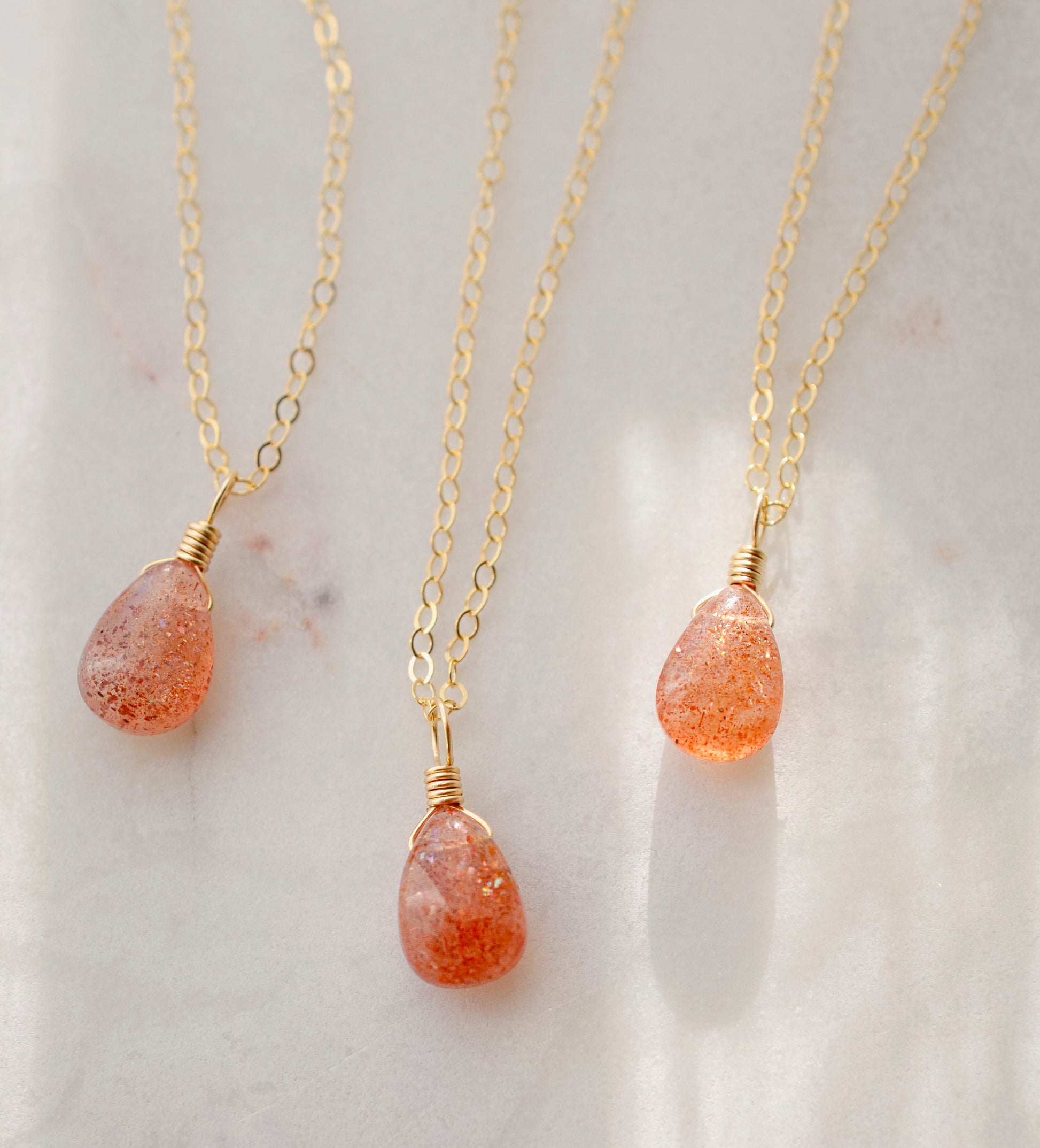 Orange Sunstone smooth polished teardrop pendant on a 14k gold filled chain. Stones shimmer in the light and when turned from side to side. 