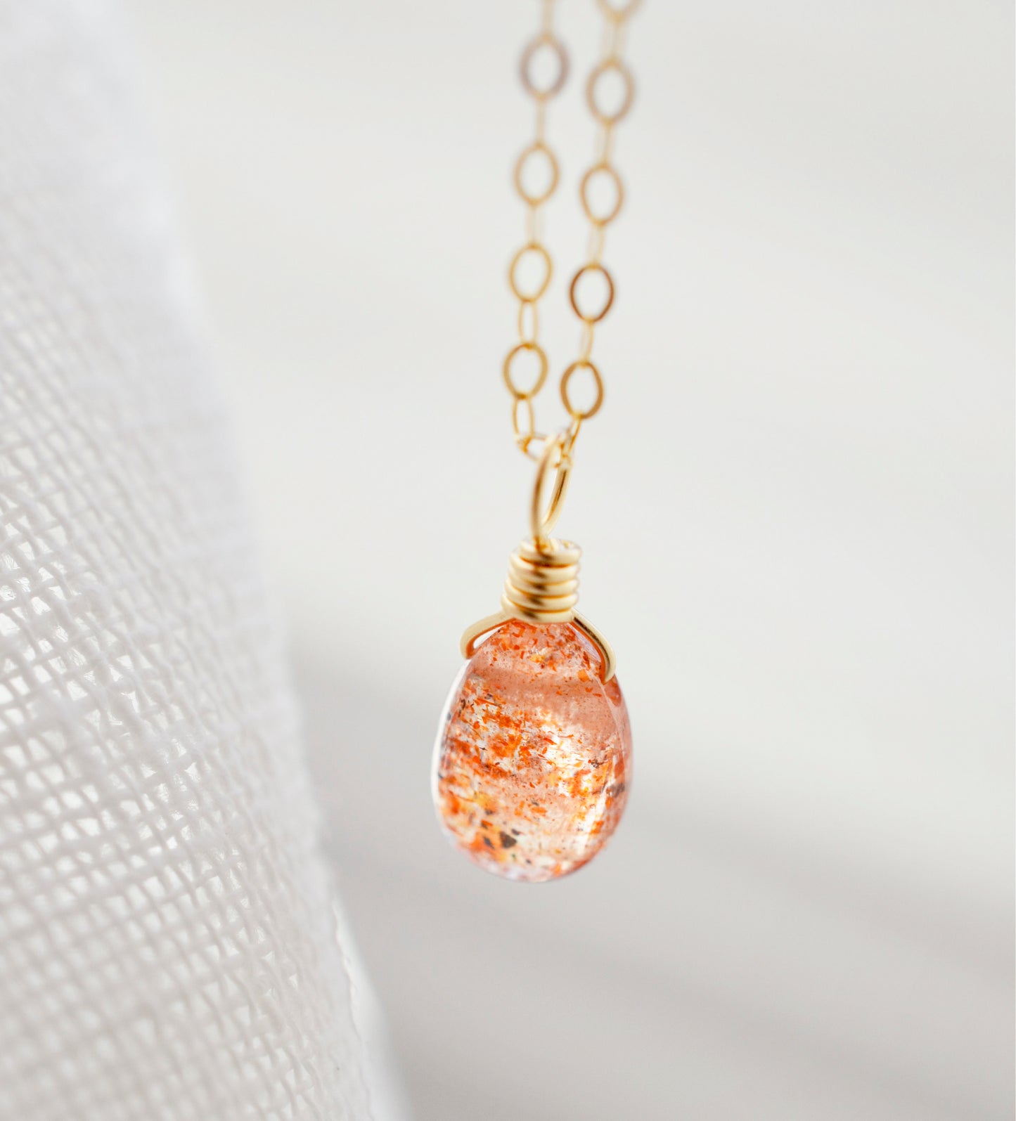 Orange Sunstone smooth polished teardrop pendant on a 14k gold filled chain. Stones shimmer in the light and when turned from side to side. 