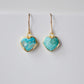Genuine, natural blue turquoise faceted hearts set on 14k gold filled earring hooks. The stones range in blue and green, with some containing white or brown.