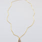 Pale pink Rhodochrosite smooth polished slice set in gold. Shown on a gold chain.