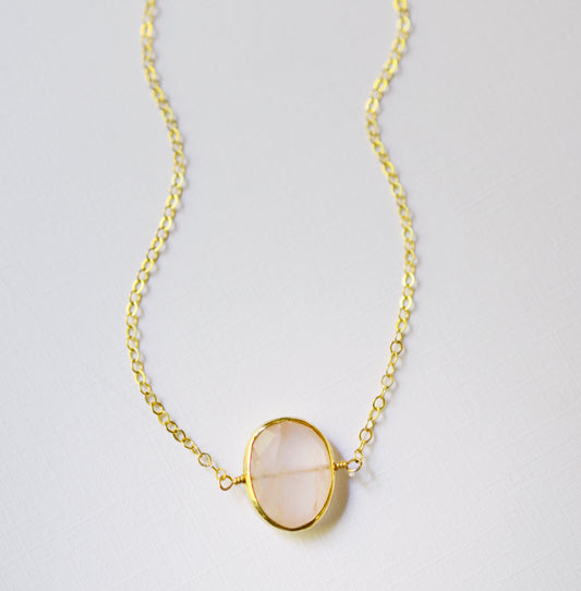 Dainty pink Rose Quartz oval coin shaped pendant with gold bezel. Chain is 14k Gold Filled.