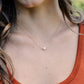 Single round white freshwater pearl necklace on a 14k gold filled chain.